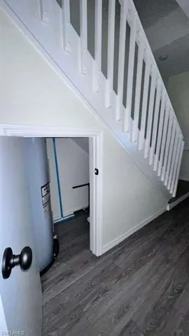White painted baluster railing with light gray wood-finish flooring