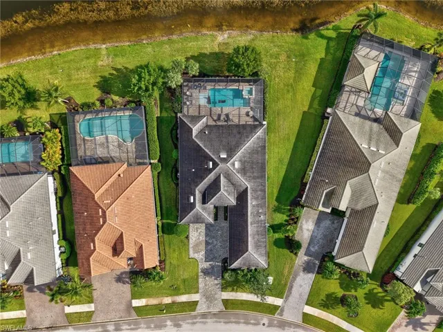 Drone / aerial view of a large body of water and a pool area
