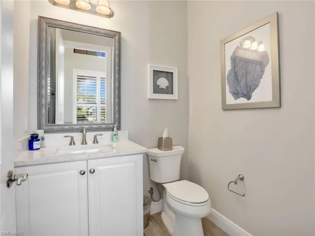 Half bathroom featuring vanity and light wood finished floors