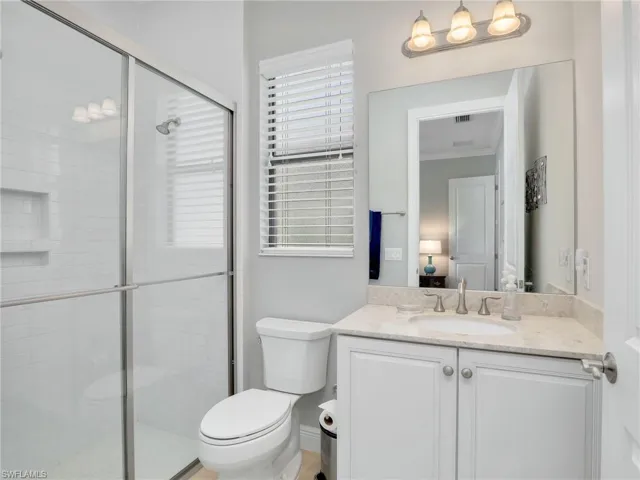 Full bathroom featuring a stall shower and vanity