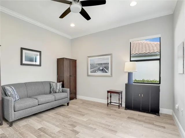 Living room featuring plenty of natural light, ornamental molding, recessed lighting, light wood-style floors, and ceiling fan