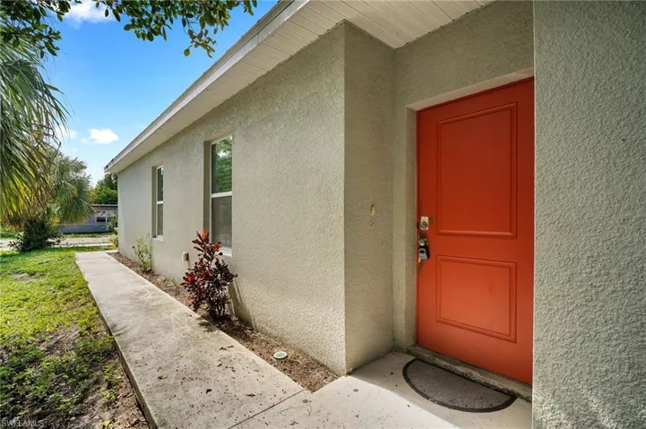 View of exterior entry with stucco siding
