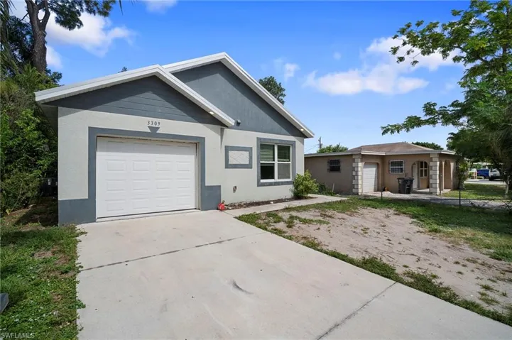Ranch-style home featuring a garage, concrete driveway, and stucco siding