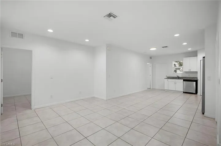 Unfurnished living room with recessed lighting and light tile patterned floors