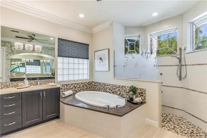 Primary bath w/large walk-in shower w/multiple shower heads