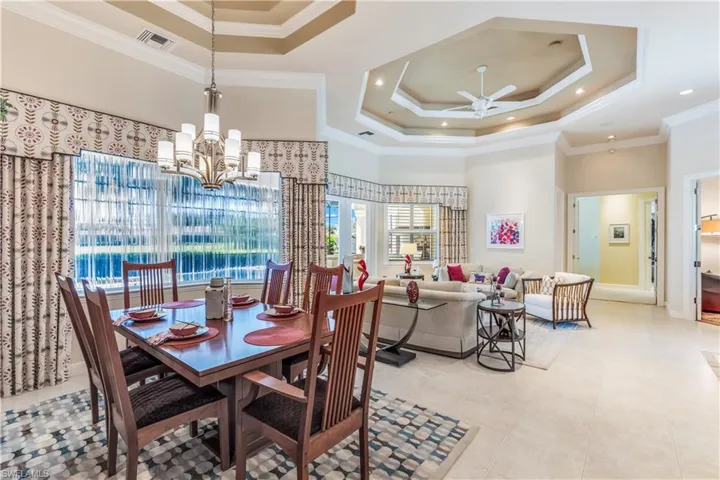 Dining room with view to living area. Wall of glass along rear of home