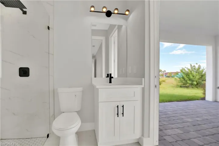 Bathroom with tile flooring, vanity, and toilet