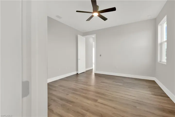 Spare room with ceiling fan and hardwood / wood-style flooring