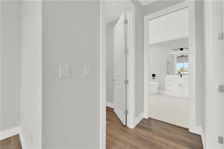 Hall with hardwood / wood-style flooring