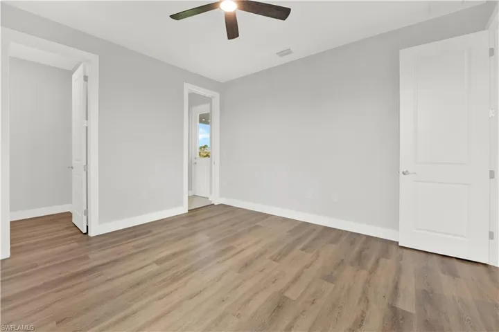 Unfurnished bedroom featuring wood-type flooring and ceiling fan