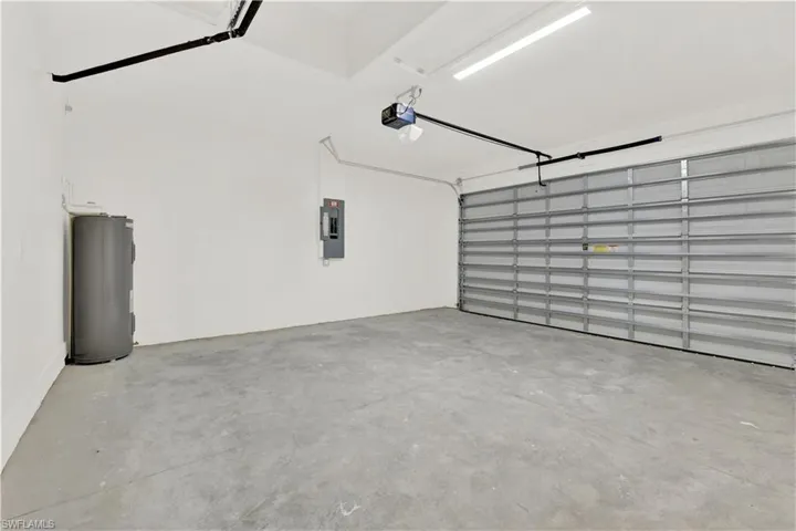 Garage with water heater and a garage door opener