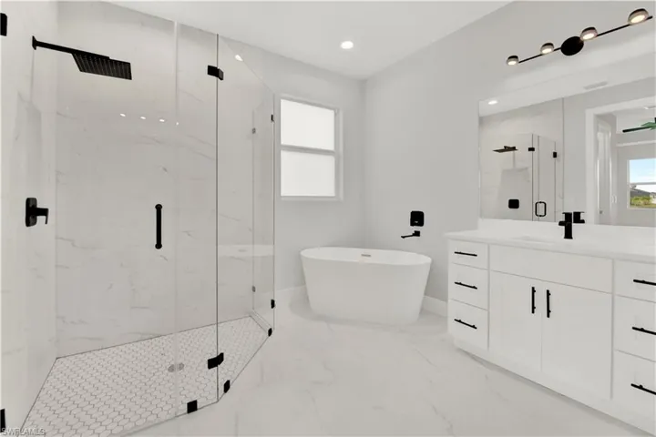 Bathroom featuring plus walk in shower, tile flooring, and vanity