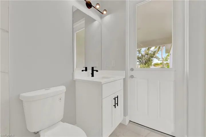 Bathroom with tile flooring, toilet, and vanity