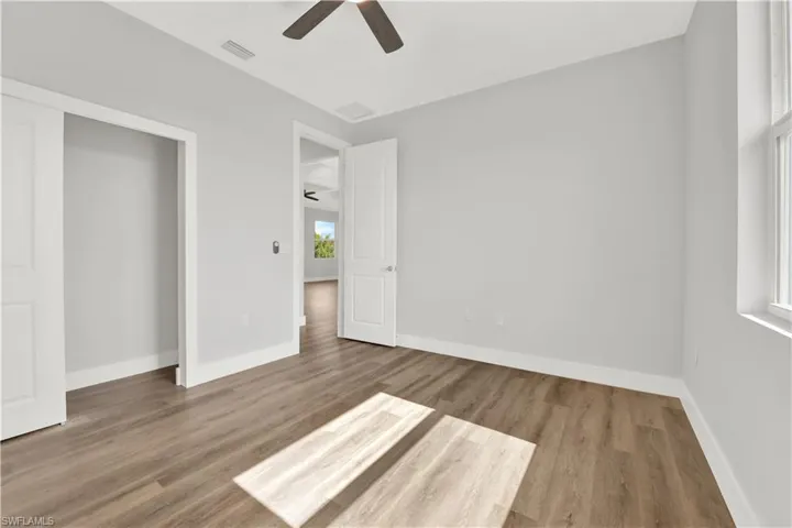 Unfurnished bedroom featuring ceiling fan and hardwood / wood-style flooring