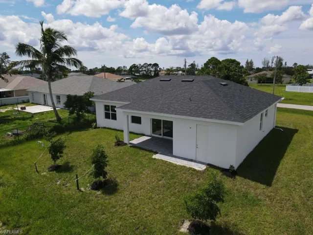 Back of house featuring a patio area and a yard