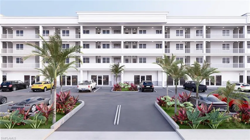 View of apartment building / complex featuring uncovered parking