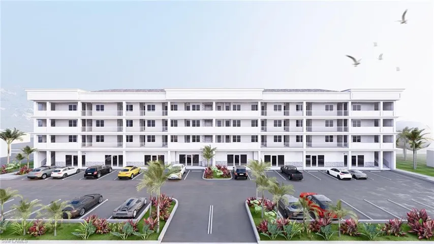 View of apartment building / complex featuring uncovered parking