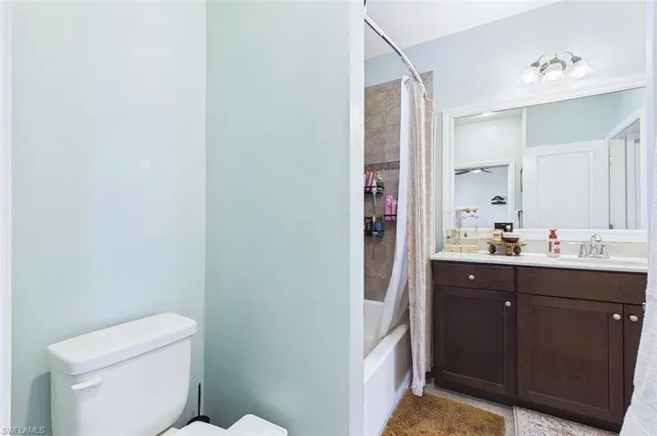 Full bath with vanity and shower / tub combo with curtain