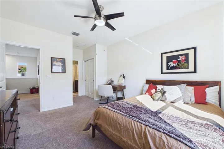 Bedroom featuring a closet, a ceiling fan, and carpet