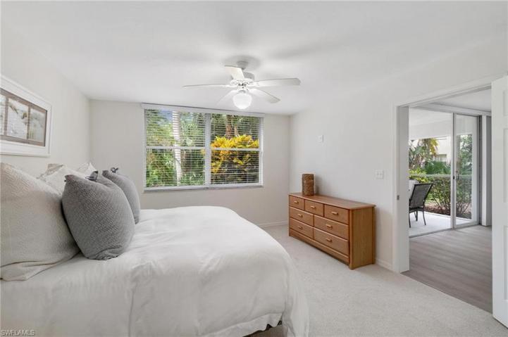 Master bedroom with large window looking out onto the private wooded area