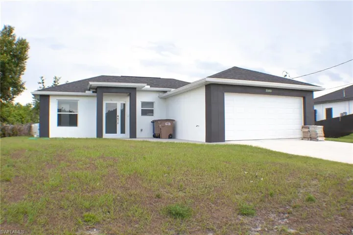 Modern exterior with white stucco finish and dark grey architectural accents