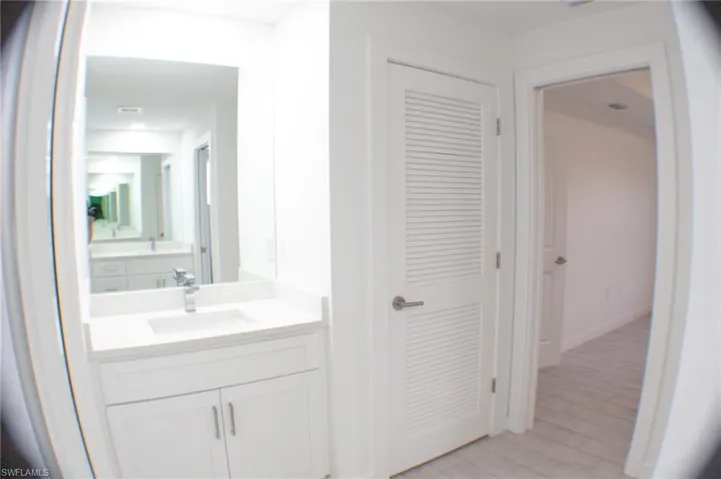 Bathroom vanity featuring a rectangular undermount sink, quartz countertop, and chrome faucet