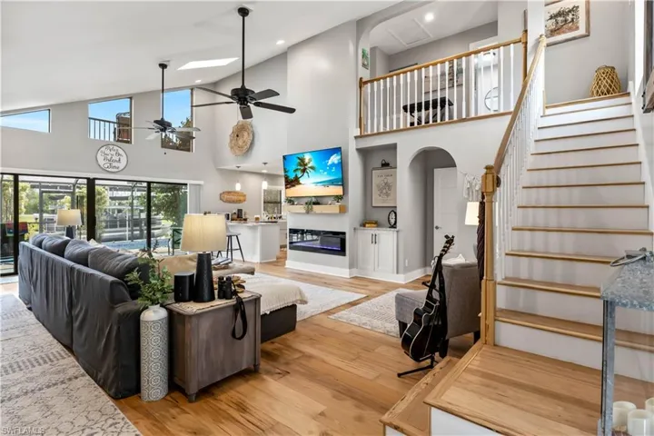 HUUUUUGE Living room with high vaulted ceilings, a wall of sliders and lots of natural light throughout! Total care and top upgrades were used when remodeling this beauty and it is apparent everywhere!
