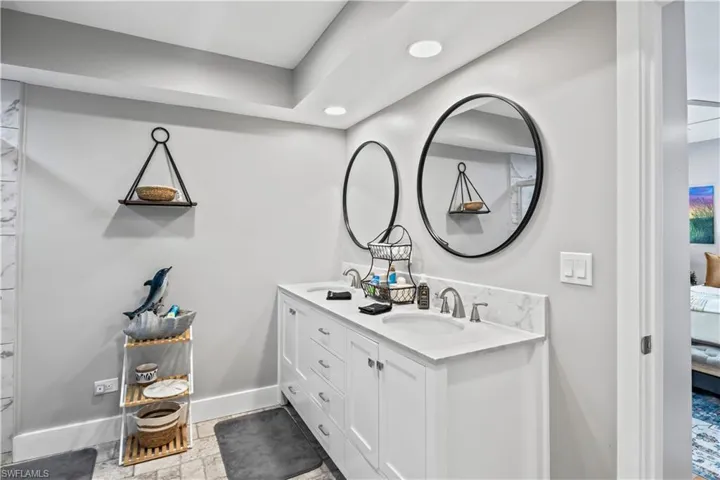 The second primary bathroom offers both style and convenience with a double sink vanity, providing ample space for two and a smooth start to the day.