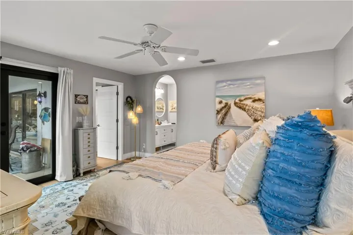 Primary bedroom featuring French doors, access to outside, light wood-type flooring, and lots of natural light!