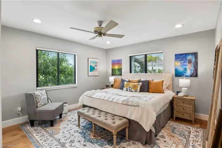 Second Master Bedroom featuring light hardwood / wood-style floors, multiple windows, and split from the other master for privacy!
