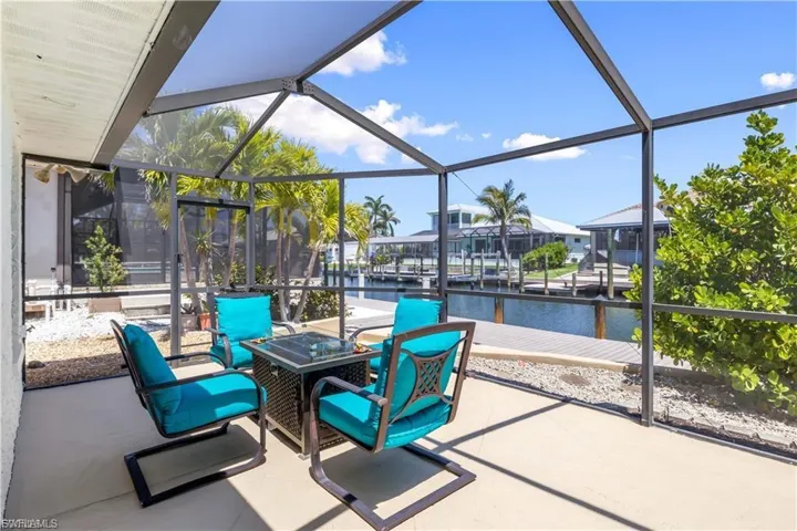 The pool area features a sparkling swimming pool surrounded by a spacious patio with comfortable seating—perfect for lounging, entertaining, or soaking up the sun.