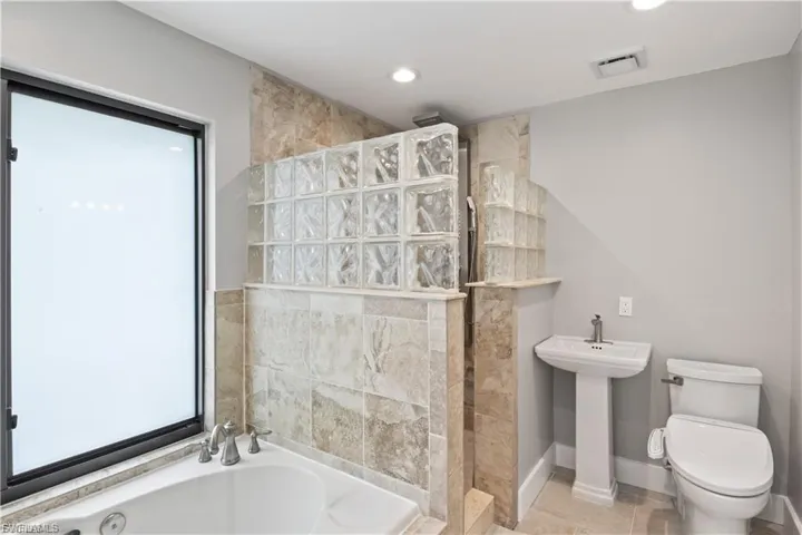 Primary bath with jacuzzi tub, large walk-in shower.