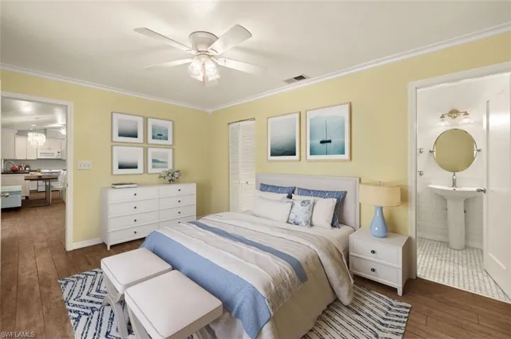 Bedroom with dark hardwood / wood-style flooring, connected bathroom, and crown molding