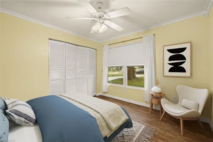 Bedroom featuring crown molding, hardwood / wood-style floors, ceiling fan, and a closet
