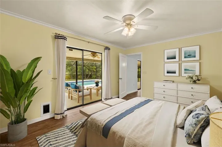 Bedroom featuring crown molding, wood-type flooring, and access to exterior