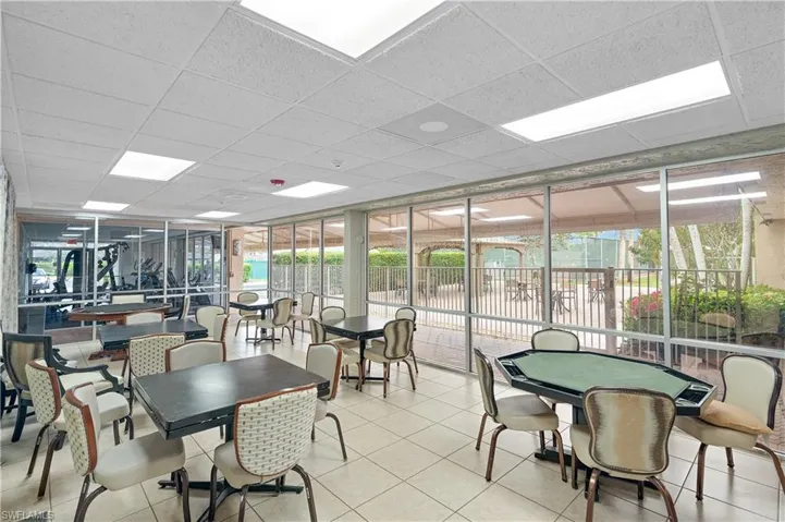 Tiled dining space featuring expansive windows and a paneled ceiling