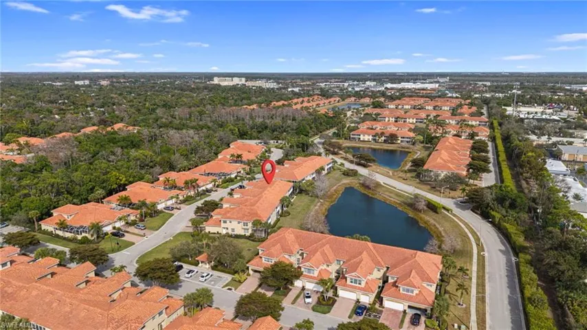 Aerial view of property's location with nearby suburban area and a large body of water