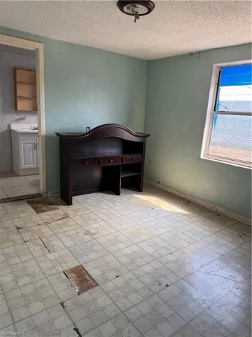 Unfurnished bedroom featuring tile patterned floors and a textured ceiling
