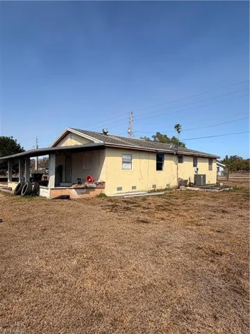 Back of house featuring crawl space and a patio area