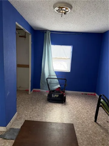 Unfurnished bedroom with a textured ceiling and a closet