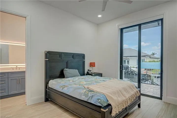 Bedroom with light wood-style flooring, access to outside, recessed lighting, and ceiling fan