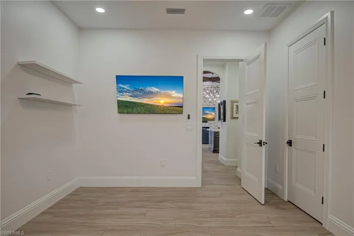 Corridor featuring light wood-type flooring and recessed lighting