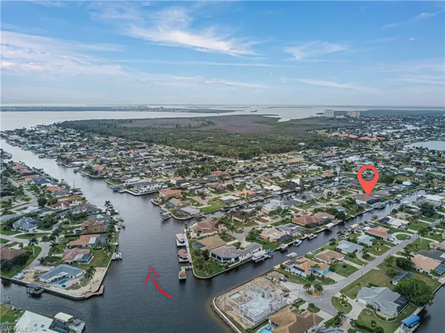 Aerial overview of property's location featuring a large body of water and nearby suburban area