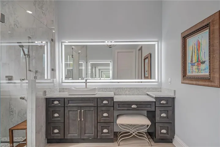 Full bath with a shower stall and vanity