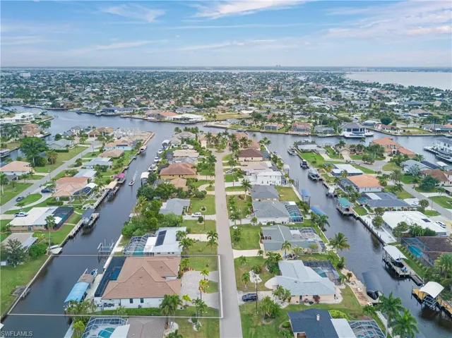 View of property location with a nearby body of water and nearby suburban area