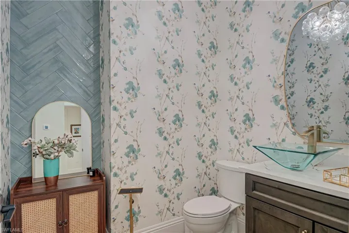 Bathroom featuring vanity and wallpapered walls