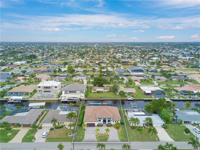 Aerial view of property's location with nearby suburban area and a large body of water