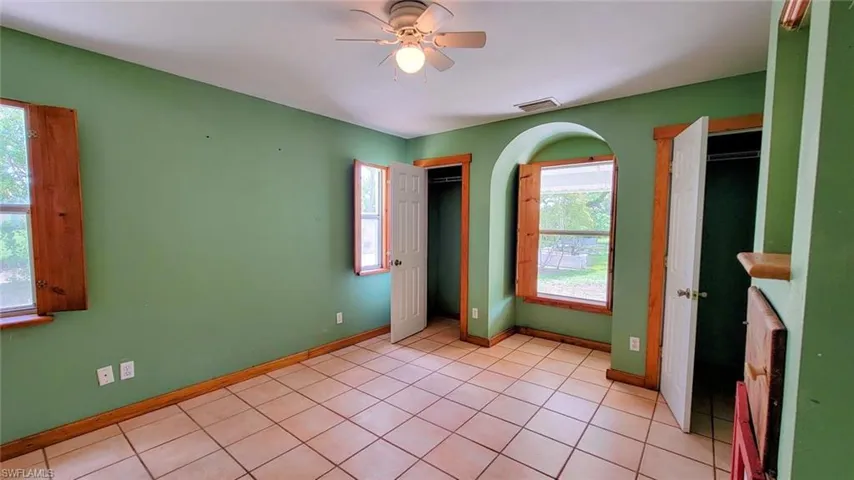 Tiled empty room featuring ceiling fan