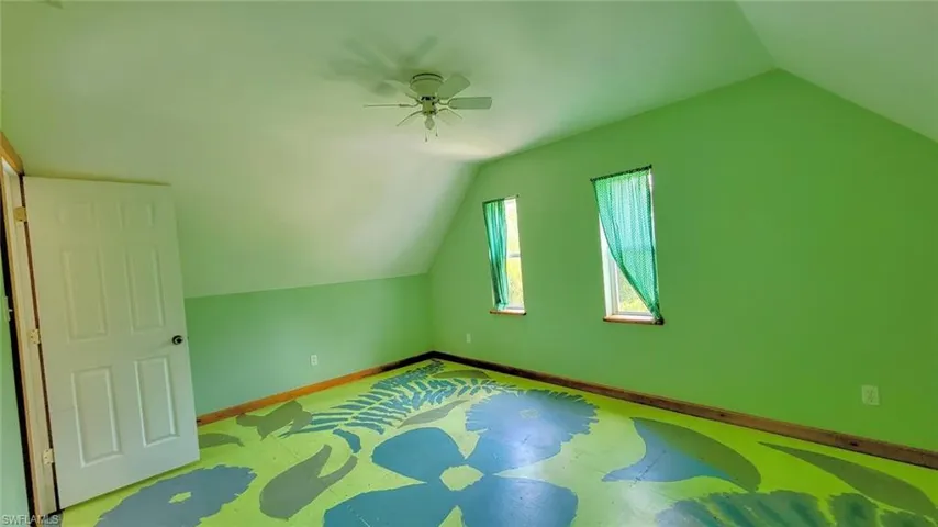 Additional living space featuring ceiling fan and vaulted ceiling