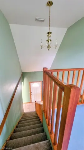 Staircase with a notable chandelier